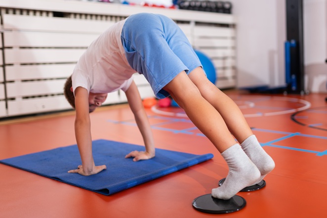 person exercising using heel sliders