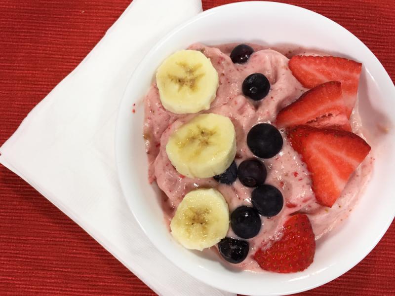 Strawberry banana soft-serve recipe in a bowl topped with fresh fruit