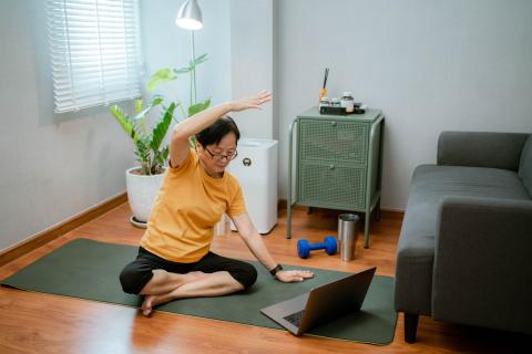 Woman doing online stretching class