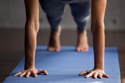 woman doing a push up on a yoga mat