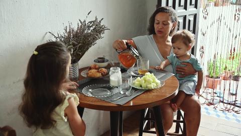 Mother and children enjoying breakfast at home