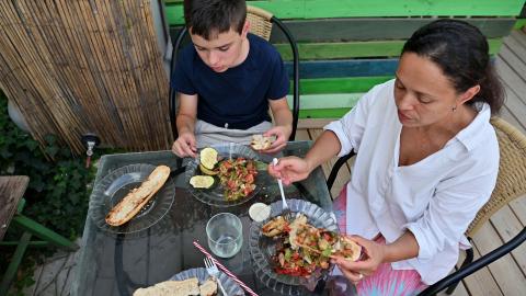 mother and son enjoy a homemade meal together outdoors