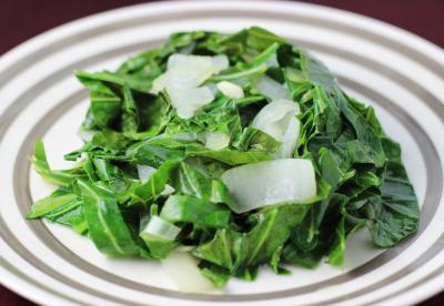 cooked collard greens on a striped plate