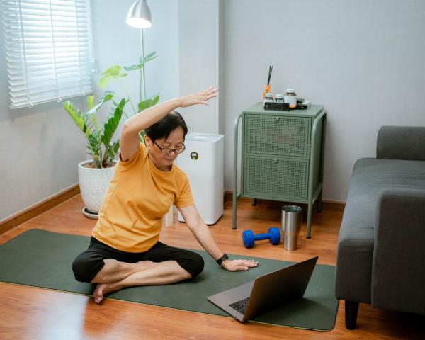 Woman doing online stretching class