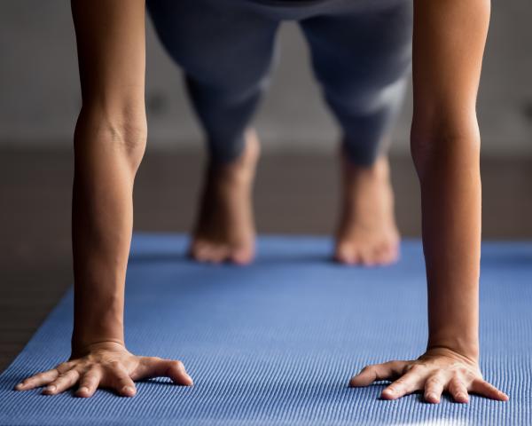 woman doing a push up on a yoga mat