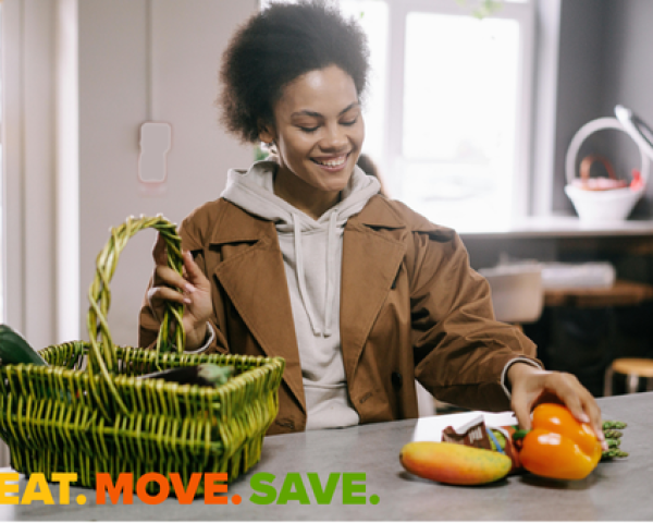 woman taking vegetables from a basket onto the countertop