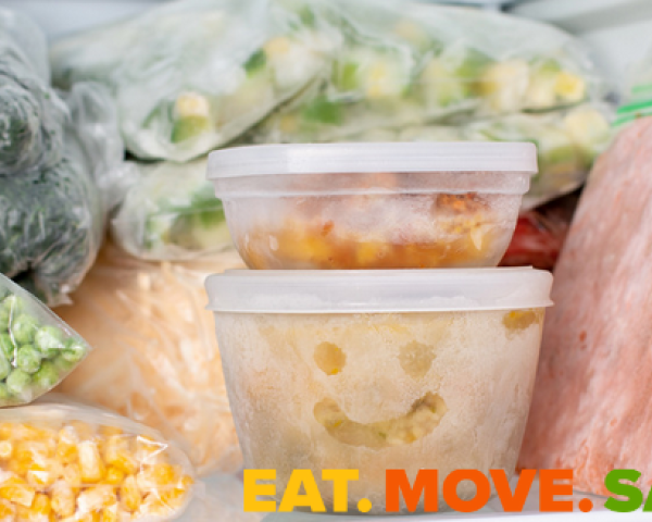 bags and containers of frozen foods in a freezer.