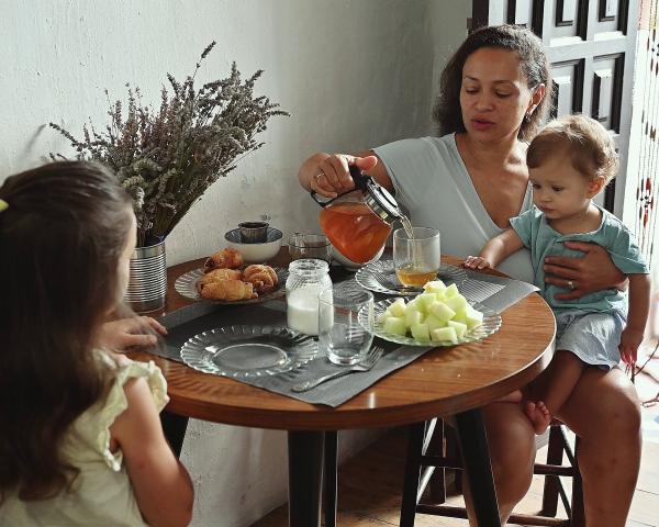 Mother and children enjoying breakfast at home