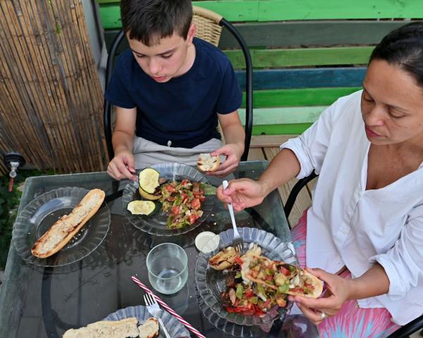 mother and son enjoy a homemade meal together outdoors