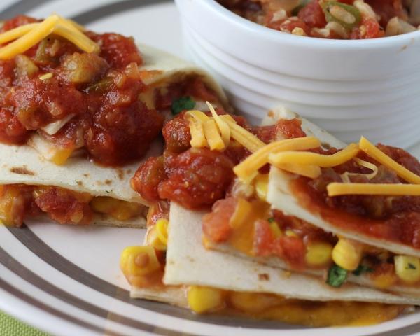 Vegetable Quesadillas topped with salsa and shredded cheese