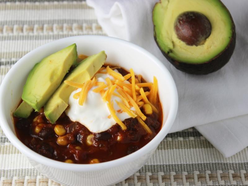 Bowl of Black Beans and Corn with Avocado, Sour Cream, and Cheese