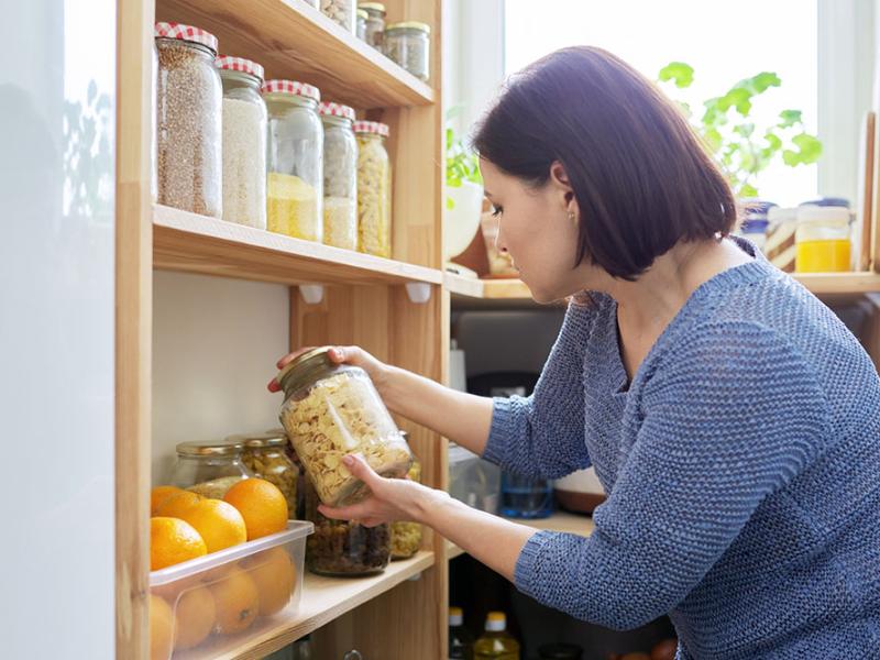 woman looking through items in pantry