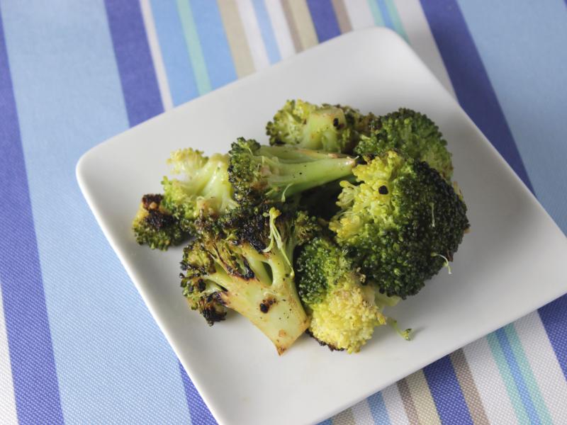 serving of stir-fried broccoli on white plate