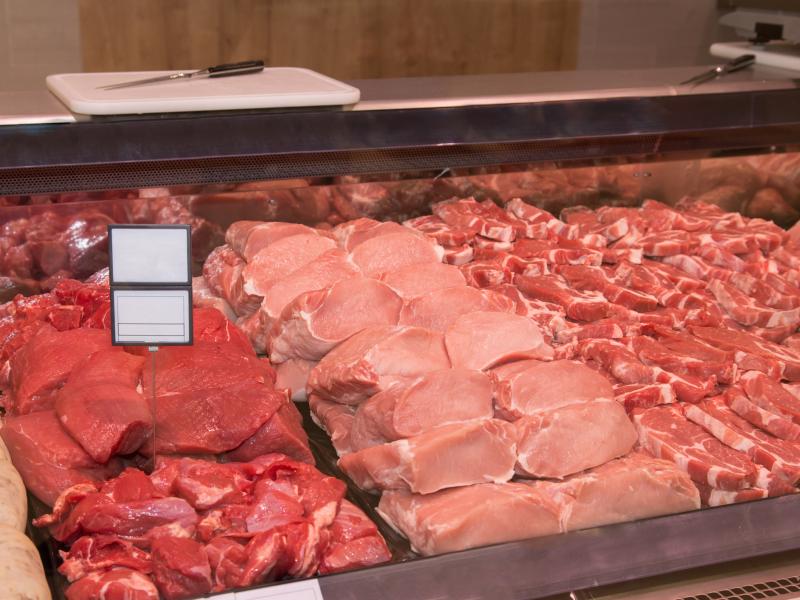 Meat department case with various raw meats