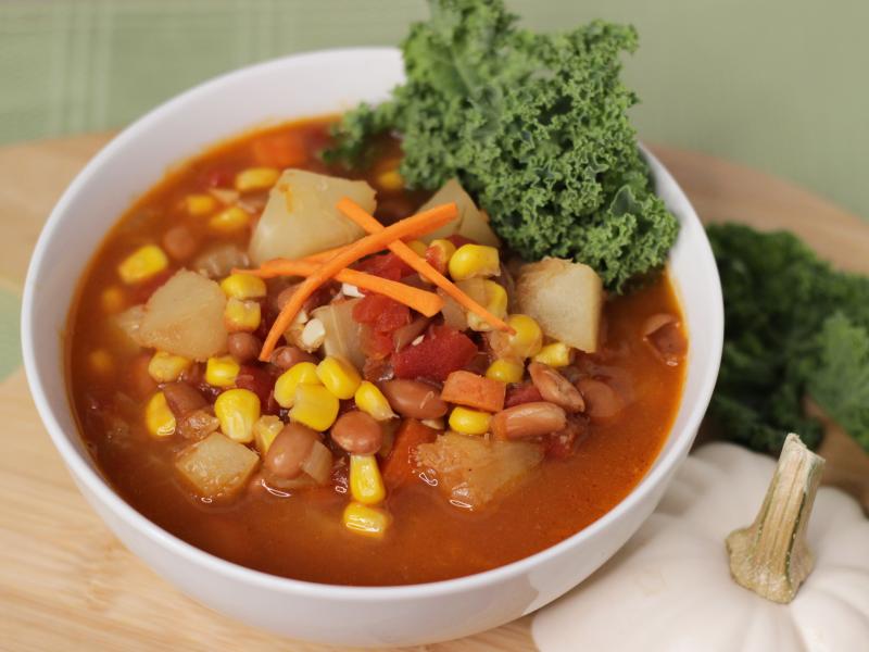 Bowl of Soup with beans, corn, potatoes and other vegetables.