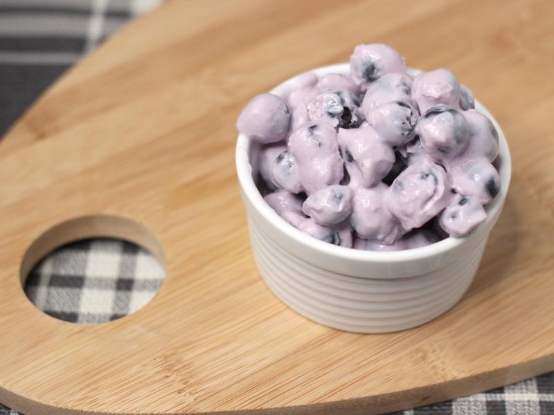 Dish of frozen yogurt-covered blueberries.