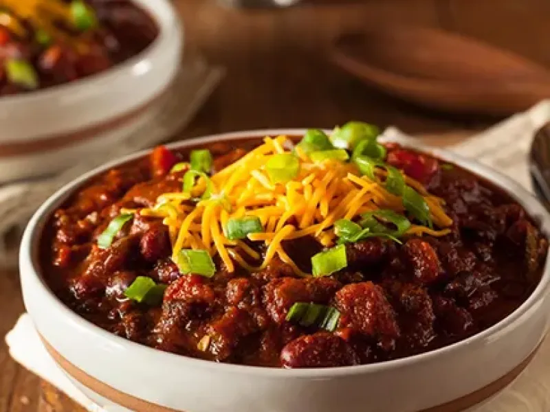 chili in a bowl with cheese on top