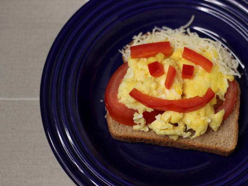 Breakfast Fun Open-Faced Egg Sandwich with peppers for face and cheese for hair
