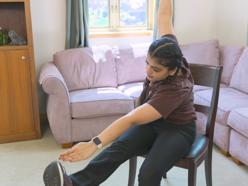 woman doing seated alternating toe touches