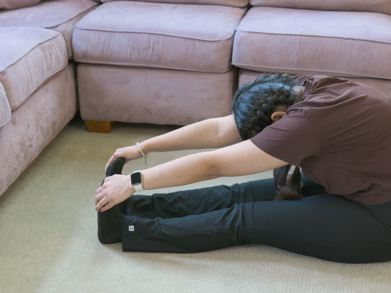 woman doing seated forward fold