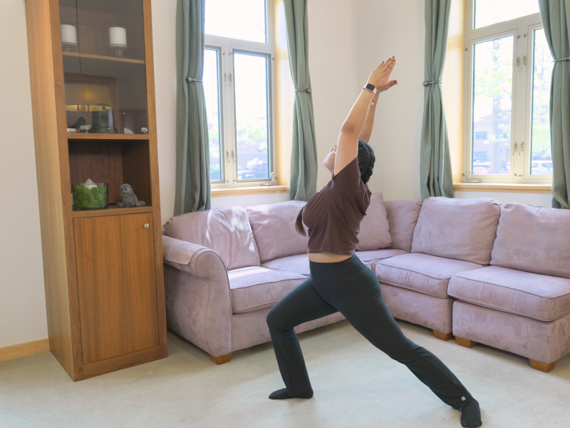 woman doing warrior one pose