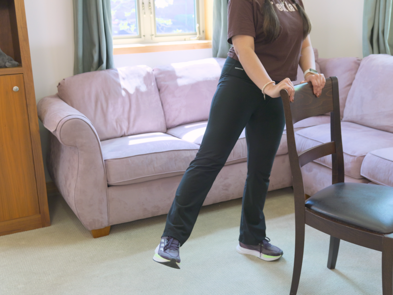 woman doing standing side leg kicks