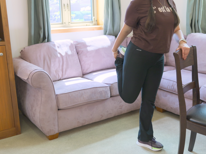 woman doing standing thigh stretch