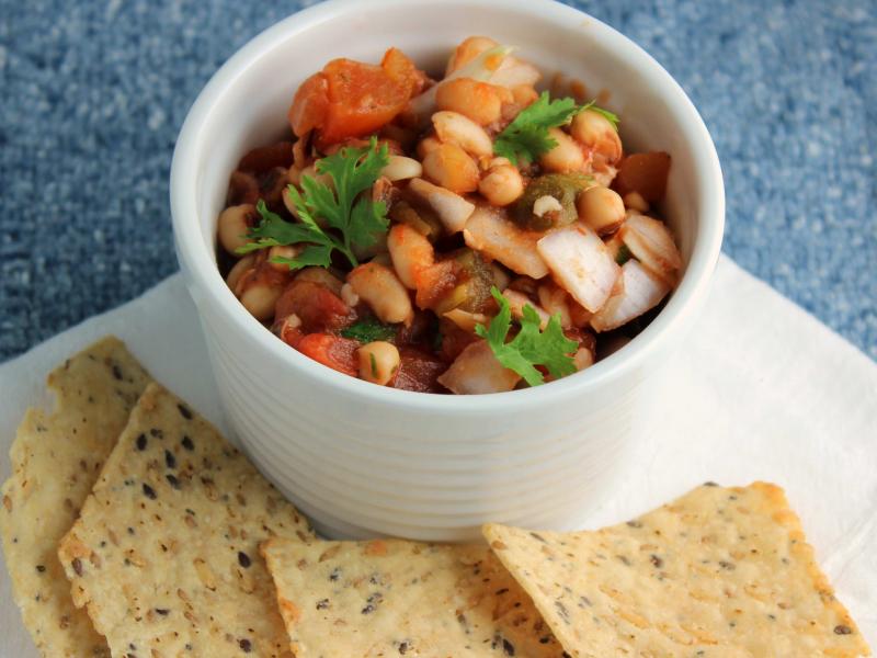 Southwest Caviar in a white dish served with whole grain crackers