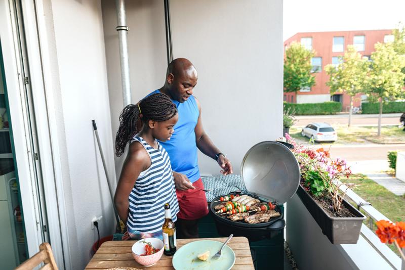 dad and daughter grilling chicken and veggie skewers