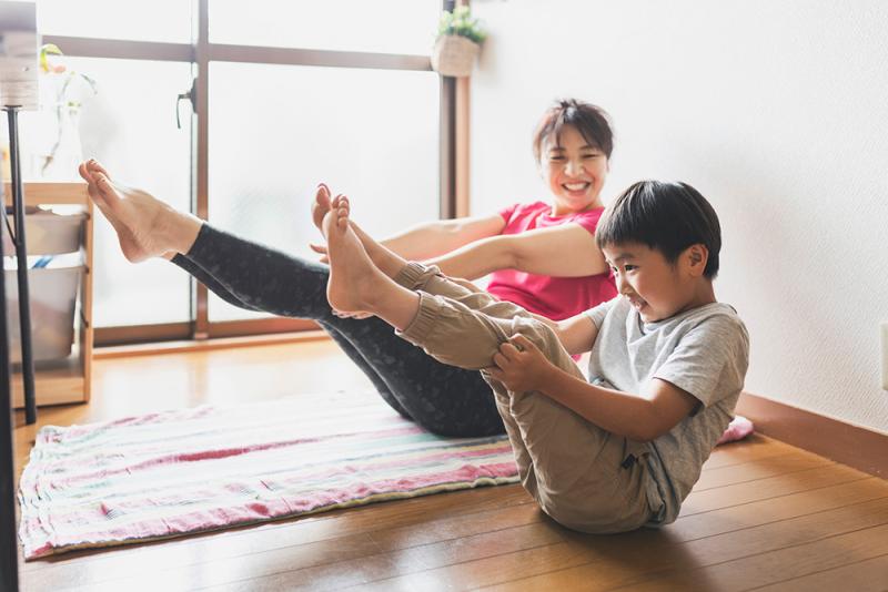 mom and son doing yoga pose together