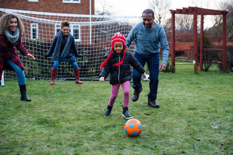 family playing soccer