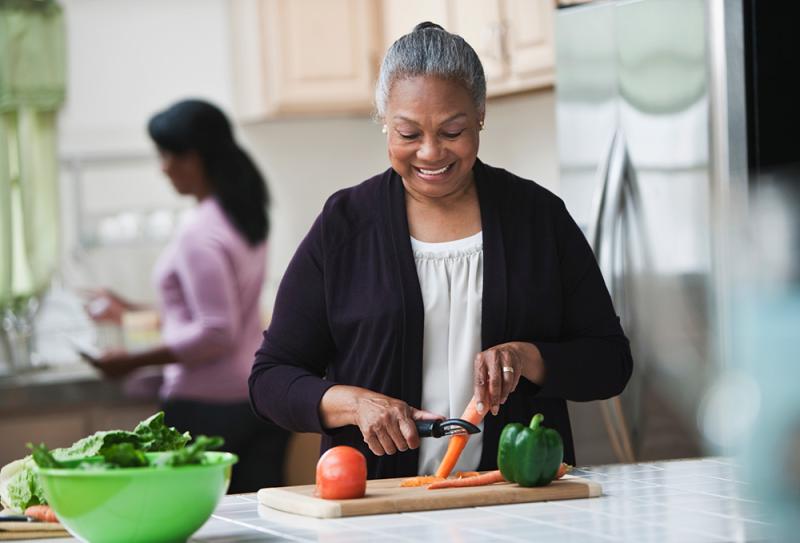 woman peeling a carrot