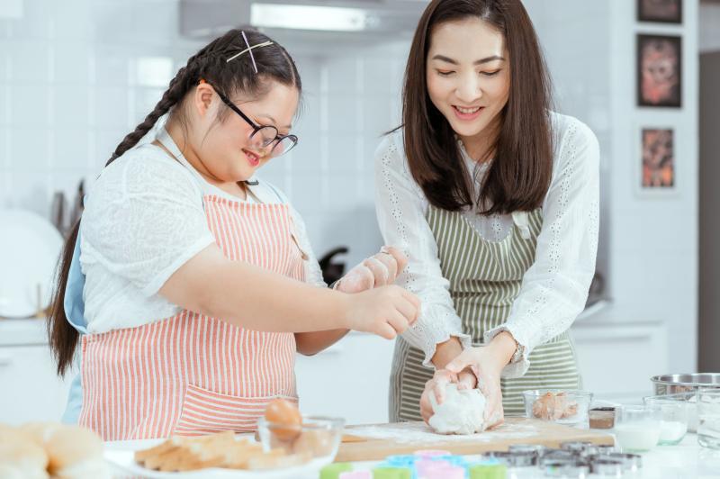 Mom and daughter baking together