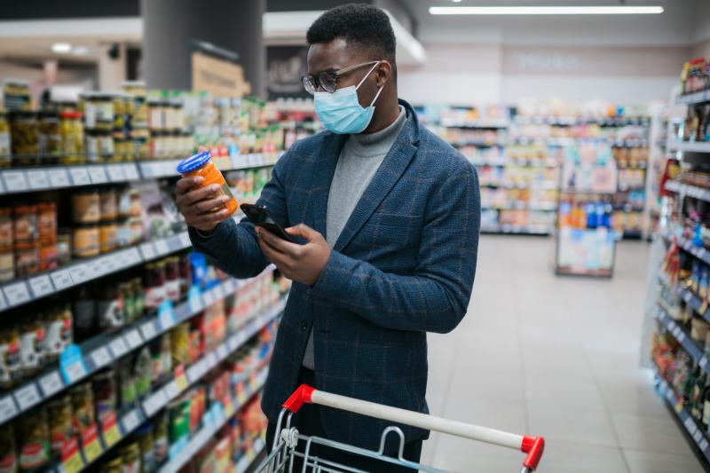 Man looking at some condiments