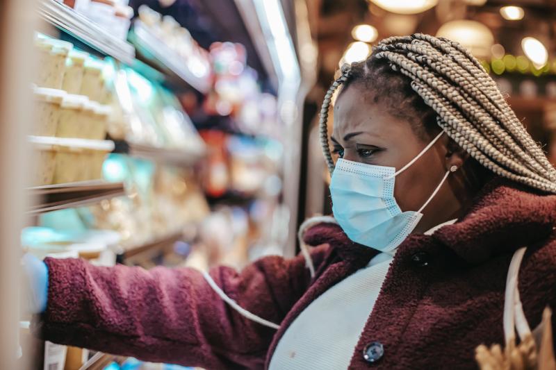 person shopping in refrigerated section of store