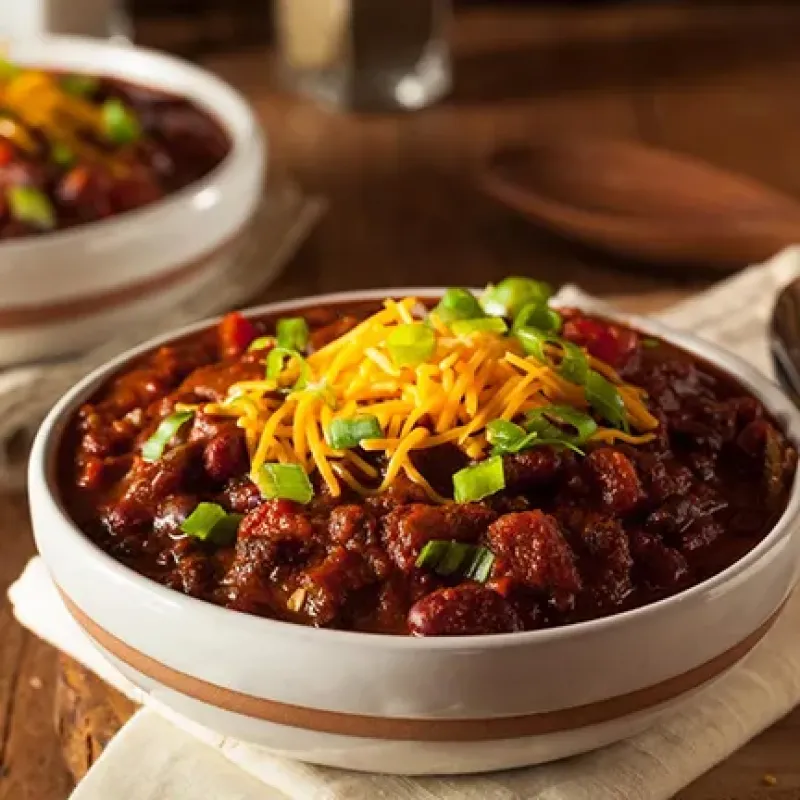 chili in a bowl with cheese on top