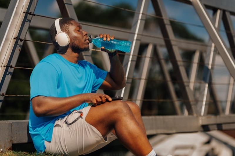 man drinking water after exercising