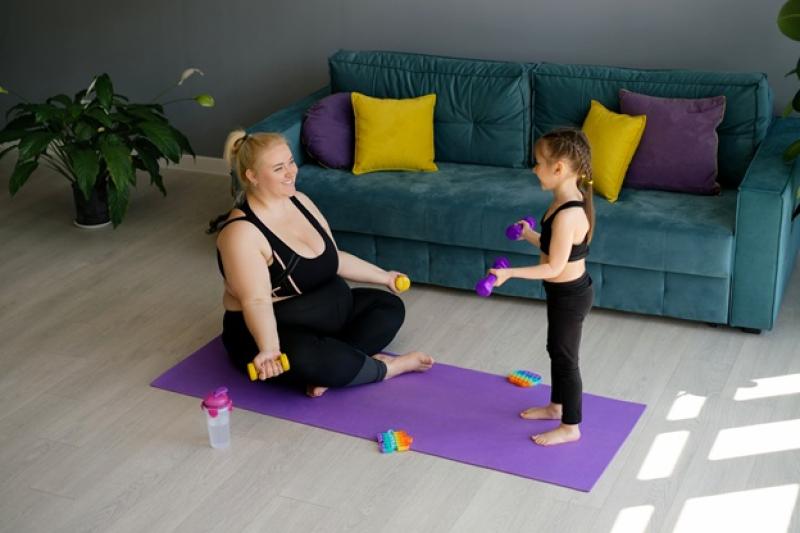 woman and child lifting hand weights in the living room