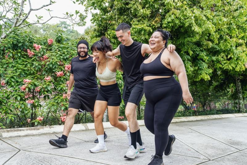 four friends walking together in a park