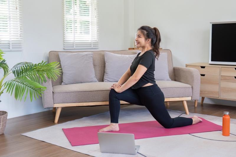 woman doing yoga in her living room